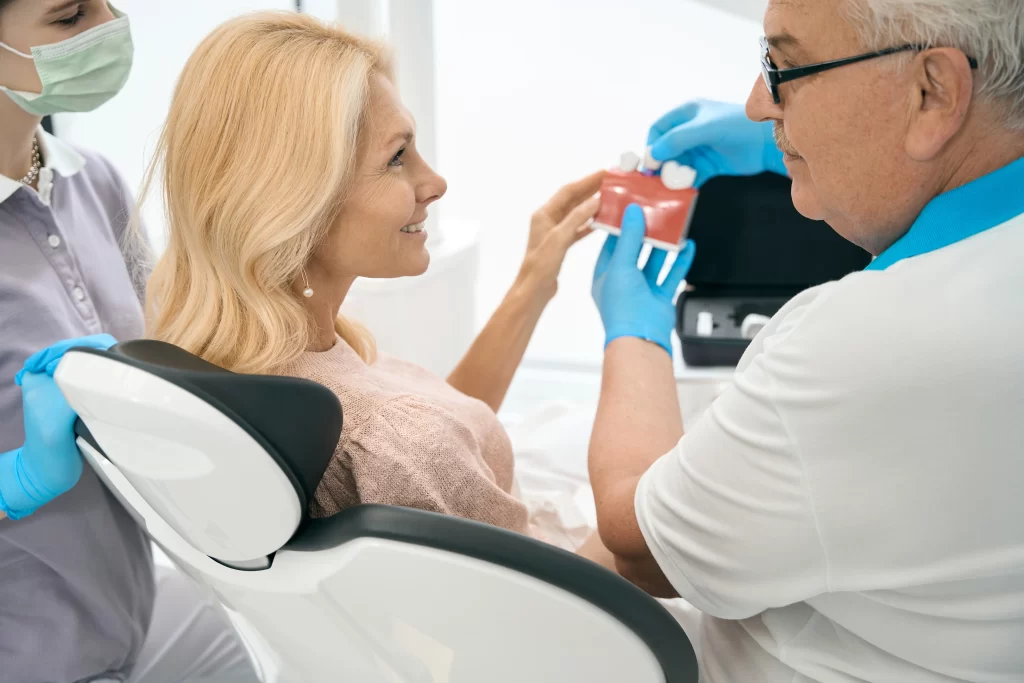 Dentist showing woman some implant options