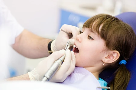 young child in dentist chair looking comfortable